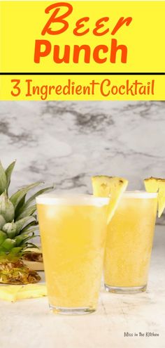 two glasses filled with pineapple punch sitting on top of a counter