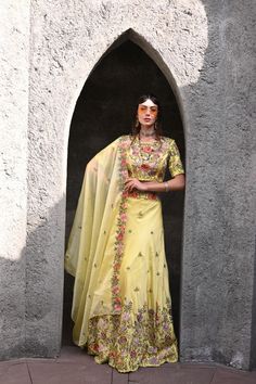 The Lemon Yellow Embroidered Lehenga Set features a vibrant yellow lehenga adorned with intricate embroidery, paired with a stylish blouse and a matching dupatta. Perfect for festive celebrations, this elegant ensemble blends traditional charm with contemporary style, making it ideal for weddings, festivals, and special occasions. Lucknowi Lehenga, Yellow Lehenga, Lehenga Suit, Green Lehenga, Embroidered Lehenga, Stylish Blouse, Intricate Embroidery, Shades Of Yellow, Lemon Yellow