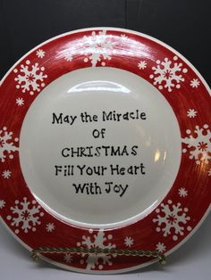 a red and white plate with snowflakes on it that says, may the miracle of christmas fill your heart with joy