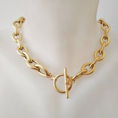 "A beautiful and unique gold plated necklace with a toggle clasp. This gold chain necklace has unique eye shaped links. Easy to match, this chunky gold  necklace will upgrade any outfit! This is a light weight necklace! links are hollow! Available in silver plating as well. Materials: 24 k gold plated brass chain and elements - matte/shiny finish  Silver plated brass chain and elements - oxidized finish Measurements: Chain width: 0.4\"/1.c\"m Clasp diameter: 0.8\"/2 c\"m Thickness: 0.12\"/3 m\"m Luxury Recycled Gold Tarnish Resistant Chain Necklace, Gold-tone Toggle Chain Link Necklace With Lobster Clasp, Elegant Chunky Toggle Necklace In Metal, Gold-plated Link Toggle Necklace, Metal Chain Necklace With Oval Link And Toggle Clasp, Metal Chain Necklace With Toggle Clasp And Oval Link, Yellow Gold Chain Link Toggle Necklace, Gold Plated Toggle Necklace, Gold Plated Toggle Necklace With Chain Link