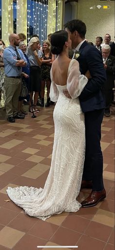 a bride and groom kissing on the dance floor