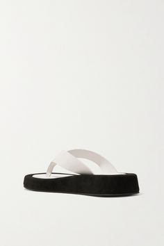 Modern Slip-on Flip Flops With Removable Insole, Modern Flip Flops With Rubber Sole, Modern Slip-on Flip Flops With Rubber Sole, Modern Leather Flip Flops For Vacation, Designer Leather Flip Flops For Beach, Designer Leather Flip Flops For The Beach, Modern Leather Beach Slippers, Designer Beach Sandals With Textured Sole, Modern Flip Flops With Textured Footbed For Vacation