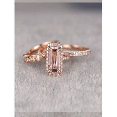 an engagement ring with a fancy pink diamond in the center and side stones on each band