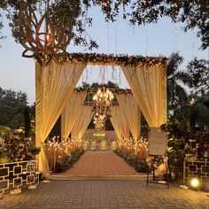 an outdoor wedding venue decorated with candles and drapes