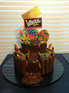 a chocolate cake with candy and lollipops on top