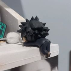 a close up of a fake animal head on a window sill with other decorations