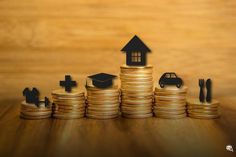 stacks of coins with houses and cars on them