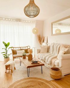 a living room filled with white furniture and lots of natural light coming through the windows