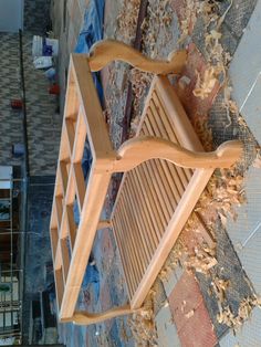 a wooden chair sitting on top of a tiled floor