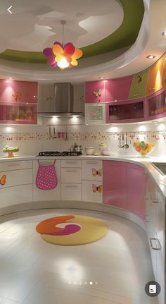 the kitchen is decorated in pink and white with lots of colorful accessories on the counters