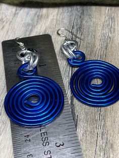 Earrings in Blue and Silver Round Circles inspired by the Zeta Phi Beta colors. Aluminum wire jewelry made by me with Love! I create fun handcrafted jewelry from anodized aluminum and sterling silver. Items are ready to ship, made to order and can be custom made to order. * Handmade Please note the picture is zoomed close to show the detail of the item *Items are handcrafted which means colors, sizes, shapes and designs may vary *Ready to ship items will be the item pictured *Made to order items Nickel-free Spiral Blue Earrings, Blue Wire Wrapped Hoop Earrings For Gift, Blue Wire Wrapped Hoop Earrings As Gift, Blue Silver Plated Wire Earrings, Blue Silver-plated Wire Earrings, Blue Silver-plated Drop Earrings, Blue Sterling Silver Wire Wrapped Hoop Earrings, Blue Spiral Sterling Silver Jewelry, Blue Wire Wrapped Sterling Silver Hoop Earrings