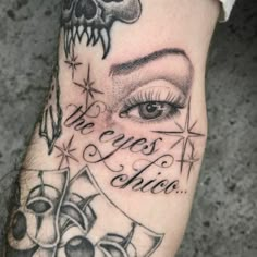 a close up of a person's arm with tattoos on it and an eye