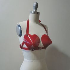 This bullet bra, or "cone bra" is inspired by retro pin-up vixens. This is the-heart-shaped version! Wear alone or layered and add a touch of drama to any outfit. Halter style straps. Buckles in front, back, and behind the neck. Silver-toned nickel plated hardware. Available in PVC, leather, and black vegan leather. Fits up to a DD cup - custom sizing available for larger cup sizes in leather, vegan leather, and clear PVC. Shown in white, clear, and red PVC. ** This is sized according to the siz Bullet Bra, Retro Pin Up, Cone Bra, Studio Space, Halter Style, Character Outfits, Looks Style, Leather Items, Product Photography