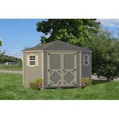 a small shed sitting on top of a lush green field