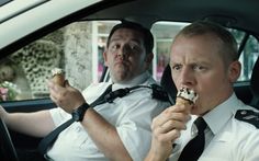 a man sitting in the back seat of a car eating an ice cream cone