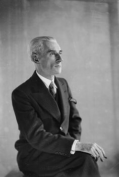 an old black and white photo of a man in a suit