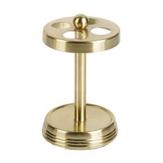 brass plated metal stand with two circular holes on the top and one round hole at the bottom