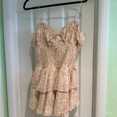 a dress hanging on a hanger in front of a door