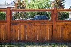 a car is parked behind a wooden fence