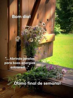 some flowers are sitting on the window sill in front of a wooden fence and grass