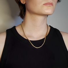 A sleek design, for an effortless style. This golden snake chain necklace can be worn alone or layered with your favorite necklaces to add texture and interest to your collection. 18" length x 3mm width Lobster clasp closure 14k gold plating over brass Made in USA Layering Snake Chain Necklace, Chic Snake Chain Necklace, Classic Gold Snake Chain Necklace For Everyday, Minimalist Snake Chain Necklace For Layering, Minimalist Gold Snake Chain Necklace, Everyday Snake Chain Necklace, Classic Gold Snake Chain Necklace, Everyday Gold Snake Chain Necklace, Chic Tarnish-resistant Snake Chain Necklace