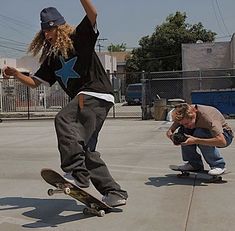 two skateboarders are doing tricks on their boards