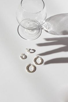 the shadow of a glass and three pairs of earrings