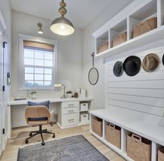 a room with white walls and shelves filled with hats