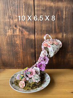 a white plate topped with lots of flowers on top of a wooden table