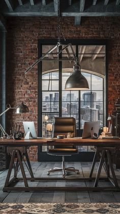 an industrial office with brick walls and exposed ceilinging, large windows, leather desk chair, and computer equipment