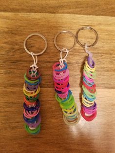 two pairs of rings are sitting on a wooden table next to another pair of earrings