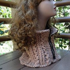 a mannequin head wearing a crocheted scarf