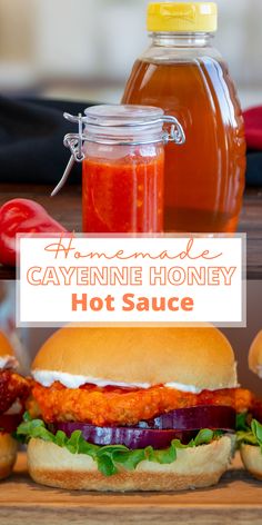 homemade cayenne honey hot sauce in a jar next to two sandwiches