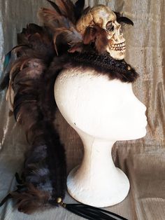 Awesome mohawk headpiece with a big skull as a center piece. The perfect mohawk to make your festival outfit complete. Brown and grey feathers around the skull and all covered with a braided brown trim and fur on the sides for an ultimate steampunk look. Light and easy to attach to the hair, this headpiece stays in place all day and night long, super confortable and party proof! Long feathers on the back side with a faux leather fringe for a more extravagant look. - - - - - - - - - - - - - - We Steampunk Halloween Festival Headpiece, Fantasy Costume Hat With Tall Crown For Festivals, Fantasy Tall Crown Costume Hat For Festival, Gothic Festival Costume Hat With Tall Crown, Fantasy Festival Headpiece With High Crown, Punk High Crown Costume Hat For Festivals, Fantasy Costume Hat With High Crown For Festivals, Punk Style High Crown Costume Hats For Festival, Bohemian Headpieces For Halloween Fantasy Events