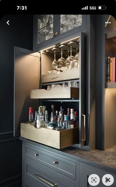 an open cabinet filled with bottles and glasses