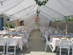 a large tent with tables and chairs set up for an event