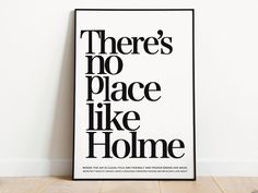 there's no place like home poster in black and white on the wall next to a wooden floor