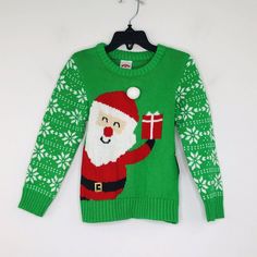 a green sweater with santa clause on it