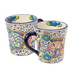 two mugs with floral designs on them