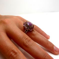 This starburst cocktail ring features a strawberry milkshake-color star ruby, artfully framed by coordinating pear shaped, pink rose colored rhodolite garnets and marquise shaped rubies. Handmade in 18k yellow gold in our signature retro-style ring by our Master Jewelers in Los Angeles. One-of-a-kind and totally fun! Gems in yummy berry colors make a great conversation piece! Ring size 7 Complimentary sizing as needed Star ruby, 9.80 x 9.13 x 5.17mm, 5.83 carats Rhodolite garnets, 2.05 carat tot Pink Marquise Ruby Ring, Elegant Pink Ruby Cabochon Ring, Elegant Pink Cabochon Ruby Ring, Handmade Pink Ruby Ring For Anniversary, Handmade Pink Oval Ruby Ring, Handmade Pink Ruby Anniversary Ring, Elegant Pear-shaped Pink Ruby Ring, Elegant Pink Pear-shaped Ruby Ring, Pink Cabochon Ruby Ring Gift