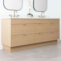 two mirrors are above the double sink vanity