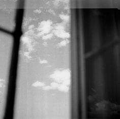 an airplane is flying in the sky through a window with a view of some clouds