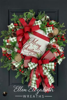 a christmas wreath on the front door with red and green bows, pine cones, evergreens and bells