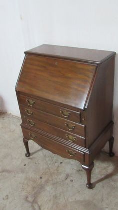 an old wooden desk with three drawers