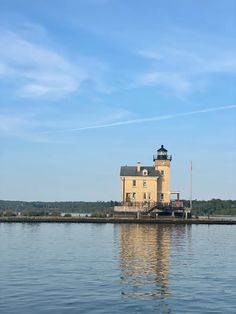 a light house sitting on top of a body of water