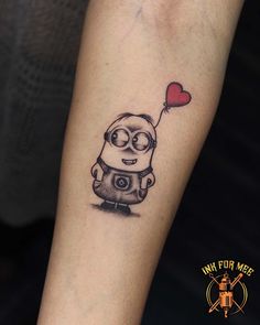 a minion with a heart balloon tattoo on the arm