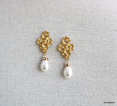 These elegant pearl earrings have small flower pendants in gold plated finish and Austrian teardrop pearls.   Pearls measure 11 x 8 mm. Earrings are approximately 1 1/2" long from top to bottom by 1/2" wide.   Each flower has a tiny clear cubic zirconia in the center.  Post is .925 sterling silver over brass.   Please choose desired pearl color and finish at checkout.  Perfect for any nature inspired bride! Matching necklace, https://www.etsy.com/listing/274801382/backdrop-pearl-necklacecrystal? Formal Gold Chandelier Earrings With Pearl Charm, Elegant Gold Pear-shaped Bridal Earrings, Gold Clip-on Earrings With Pearl Drop For Wedding, Elegant Gold Chandelier Earrings With Pearl Drop, Gold Pear-shaped Teardrop Earrings With Pearl Charm, Gold Pear-shaped Pearl Drop Earrings, Gold Pearl Embellished Chandelier Drop Earrings, Gold Pearl Charm Drop Bridal Earrings, Gold Teardrop Pearl Drop Clip-on Earrings