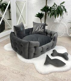 a dog bed with two pillows on top of it