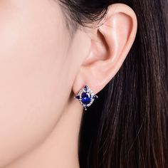 Straightforward in design and unmatched in color, these striking sapphire stud earrings are ideal for everyday wear. Created in sterling silver, each earring features a oval cut stone sparking at its center, while additional blue pear-cut stones line the glittering halos for extra shimmer. An imaginative look you'll adore, these earrings are unsurpassed with magnificence and sparkle.Carat Weight: 2 ctStone Size: 6*8 mmStone Type: Jeulia® StoneNumber of Stones: 1 Stone Color: Sapphire BlueStone S Sapphire Earrings With Gemstone Accents For Anniversary, Oval Earrings With Gemstone Accents And Cubic Zirconia, Oval Earrings With Gemstone Accents In Cubic Zirconia, Oval Cubic Zirconia Earrings With Gemstone Accents, Oval Birthstone Earrings In Cubic Zirconia, Blue Oval Earrings With Diamond Accents, Oval Cubic Zirconia Birthstone Earrings, Oval Blue Diamond Earrings, Sterling Silver Sapphire Earrings With Diamond Accents