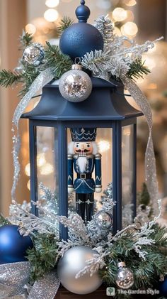 a christmas lantern with ornaments and decorations around it